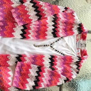 White blouse with attached cardigan and necklace.